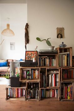 a bookshelf filled with lots of books in a living room