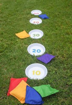 the number ten is placed in front of several colorful kites on the green grass