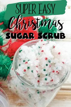 christmas sugar scrub in a glass bowl next to candy canes and other holiday decorations