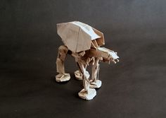 an origami star wars at - at walker is shown on a black background