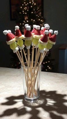 a glass filled with marshmallows and santa hats
