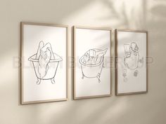 three framed art prints hanging on the wall above a toilet and bathtub in a bathroom