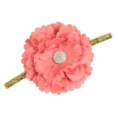a pink flower with gold sequins on it's headband is shown in front of a white background