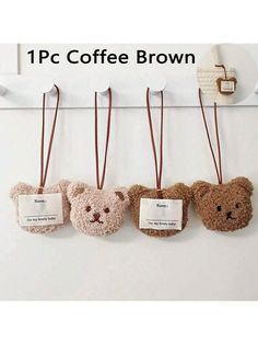 there are four teddy bears hanging on the wall with name tags attached to each one