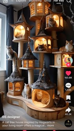 a cat house made out of wood with cats sitting on it