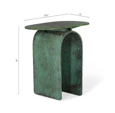 the side table is made out of green pattered metal