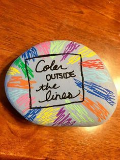 a rock that has been painted with the words,'calm outside the lines '