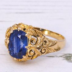 A fine Victorian sapphire ring. The sapphire - certified as originating from Ceylon (Sri Lanka) - is a deep, vivid blue with clear flashes of bright azure. The stone is set in an 18k yellow gold Victorian mount featuring intricate and ornate scroll work and foliate detailing in the gallery and down the shoulders. Accompanied by a sapphire report from The Gem & Pearl Laboratory stating the sapphire is Sri Lankan (Ceylon) in origin. Cut - Cushion cut. Colour - Blue. Clarity - Eye clean. Carat - Ap Cushion Cut, Ceylon Sri Lanka, Sapphire Solitaire Ring, Scroll Work, Sapphire Solitaire, Ceylon Sapphire, Blue Gems, Sri Lankan, Colour Blue