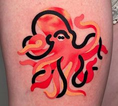 an orange and black octopus tattoo on the thigh, with red flames coming out of it