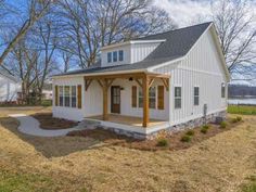 a small white house with a covered porch