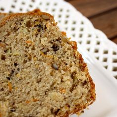 two slices of banana bread on a white plate with a wooden table in the background