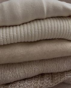 four different types of sweaters stacked on top of each other in various sizes and colors