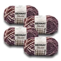 three skeins of bernat blends yarn in purple, red and white