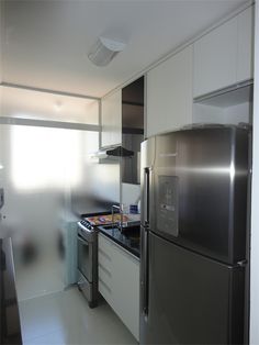a stainless steel refrigerator freezer sitting in a kitchen next to a stove top oven