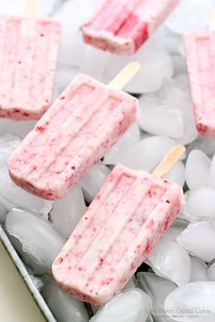 three popsicles sitting on top of ice cubes