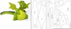 a green stuffed dragon sitting next to cut out pieces of paper and the instructions for how to make it