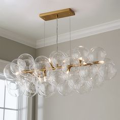 a chandelier with clear glass balls hanging from the ceiling