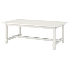 a white table sitting on top of a white floor