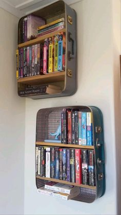 two metal bookshelves mounted to the side of a wall filled with books and dvds