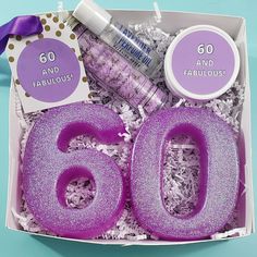 purple glitter 60th birthday gift box with candles, confetti and candy in it