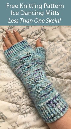 a woman's hand wearing a blue knitted arm warmer on top of a bed