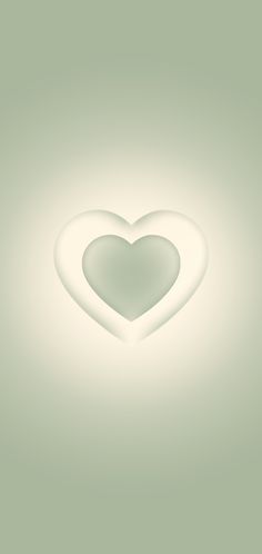 a white heart shaped object on a light green background with room for text or image