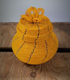 a yellow basket sitting on top of a wooden table