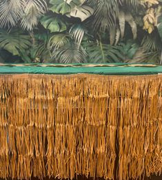 an umbrella is sitting on the ground in front of a wall with plants and foliage