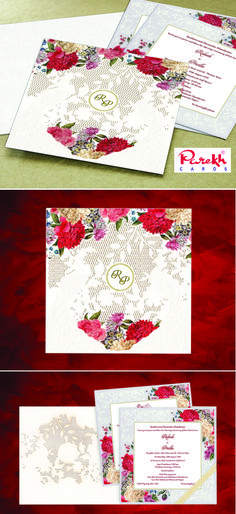 the wedding card is decorated with red flowers