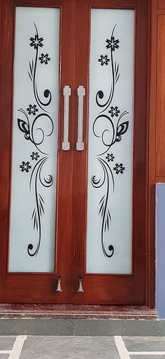 the front door is decorated with flowers and leaves