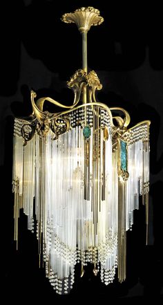 a large chandelier with many lights hanging from it's sides on a black background