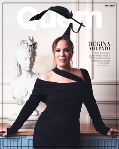 a woman in a black dress on the cover of cuen magazine, with a statue behind her