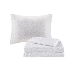 two pillows and one pillow case with white flowers on the front, both are folded up