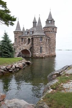 an old castle sitting on top of a lake