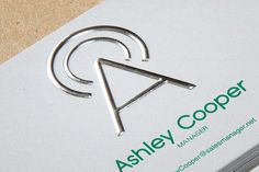 a close up of a business card with an arrow logo on the front and back