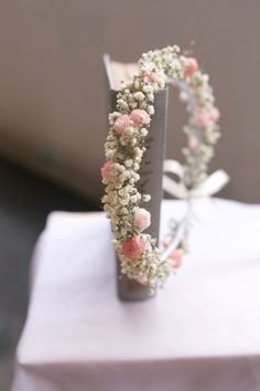 flowers are arranged in the shape of a heart on top of a white table cloth