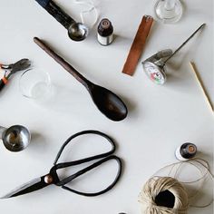 a table topped with lots of different types of utensils and other things on top of it