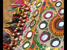 a close up view of a multicolored purse with beads and tassels
