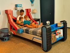 two children are sitting on a bed with slides