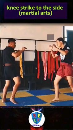 two people are practicing martial moves in the gym