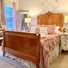 a bedroom with a bed, dresser and two lamps on either side of the bed