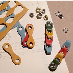 paper clips, scissors and other crafting supplies laid out on top of a piece of paper