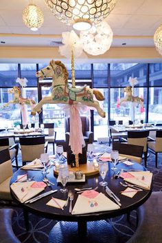 the dining room is set with fancy tables and chairs, along with unicorn figurines