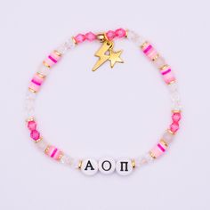 "Our Alpha Omicron Pi sorority bracelet is a beautiful and meaningful piece of jewelry to show pride in your sisterhood. It's the perfect gift for your big, little, sorority sister, or daughter in greek life! Handmade with love and created with high-quality materials (see specifications below) this bracelet will stand the test of time, and be a bracelet you can take with you for the rest of your life. Get one for yourself, or get multiple to match with your big, little, or entire family! Available in 5 color-ways. Looking to order in-bulk for your entire sorority or a larger group of girls? We have bulk-discounts, send us a message! Available in Pink, Purple. White, Blue, & Orange. Small  - 6.5\"  Average - 7\" Large - 7.5\" Specifications: -Hand-crafted crystal, gemstone and gold beaded b Sorority Bracelets, Letters Sorority, Bid Day Gifts, Big Little Basket, Big Little Sorority, Delta Delta Delta, Sorority Jewelry, Hardware Jewelry, Alpha Omicron Pi