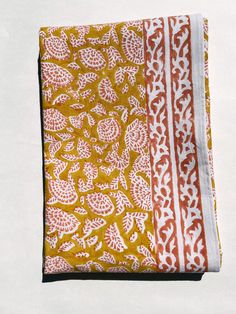 an orange and white cloth with designs on it