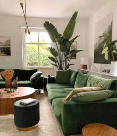 a living room filled with green couches and tables