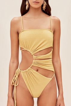 The Allegra one piece features signature Cult Gaia cutouts in a sunburst form. An adjustable tie at the right hip allows for secure fit. Shoulder straps are removable for customized wear. 10% of her fabric is composed of metallic paillettes to give some refined shine. She is slightly textured, which provides an effect of extra coverage. A gold-toned, brushed brass Cult Gaia logo can be found at the center back. Swimwear 2024, Cut Out One Piece Swimsuit, Swimsuit For Women, Swimwear Trends, Cut Out One Piece, Swimming Outfit, Poses References, Cult Gaia, Cute Swimsuits