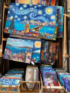 paintings are on display at an outdoor market