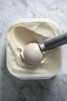 an ice cream in a plastic container with a spoon