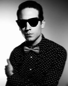 a man wearing sunglasses and a bow tie